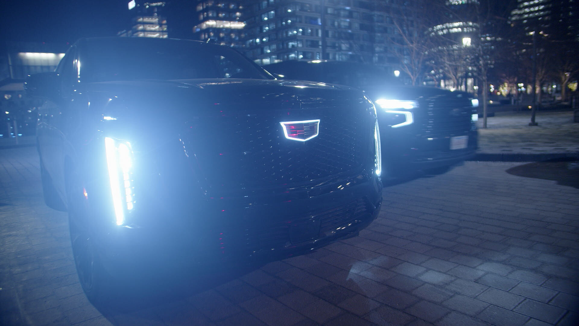Black Cadillac Escalade in the LIMO fleet under city lights