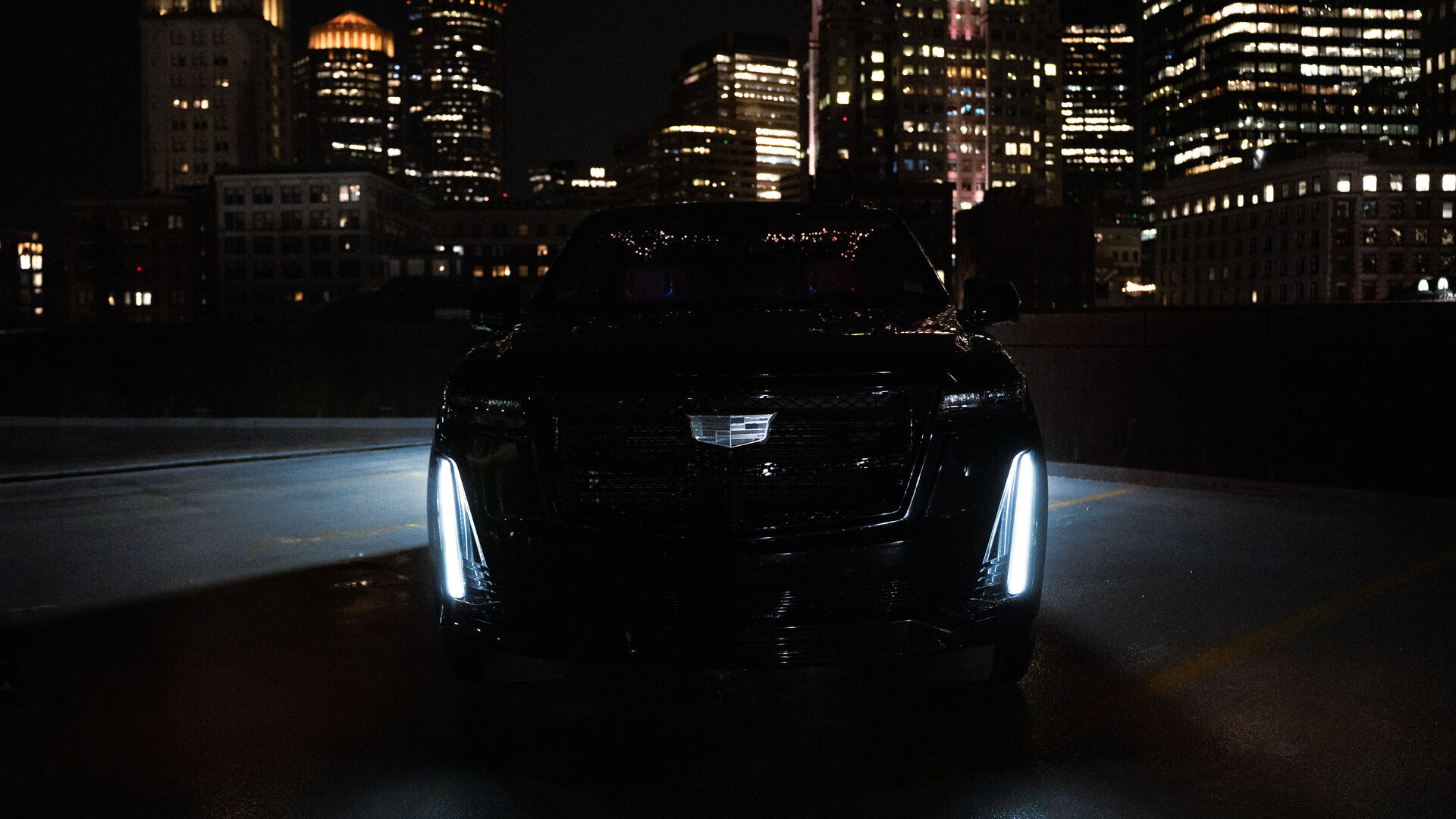 Black Escalade waiting under porte-cochère for a returning member